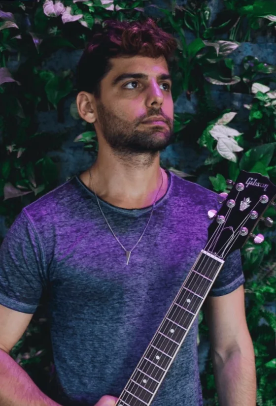 Daniel Weiss holding his guitar