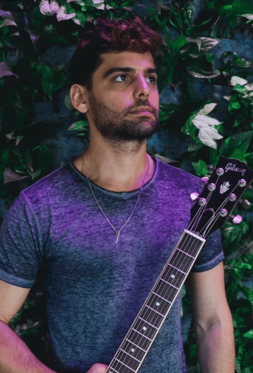 Daniel Weiss holding his guitar